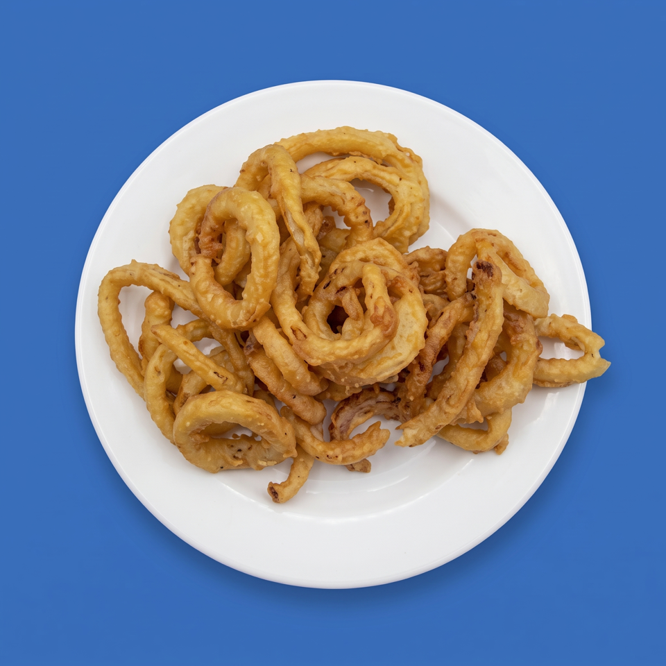 Crispy golden fried onion rings piled on a white plate against a bright blue background.